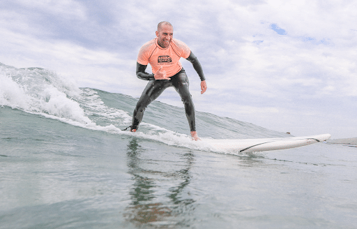 Man making a cool pose while surfing a wave 