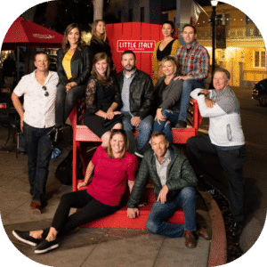 Tour group sitting on red little italy chair