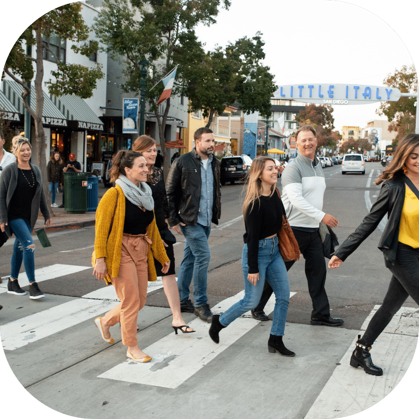 group of people walking through Little Italy during their private tour of San Diego