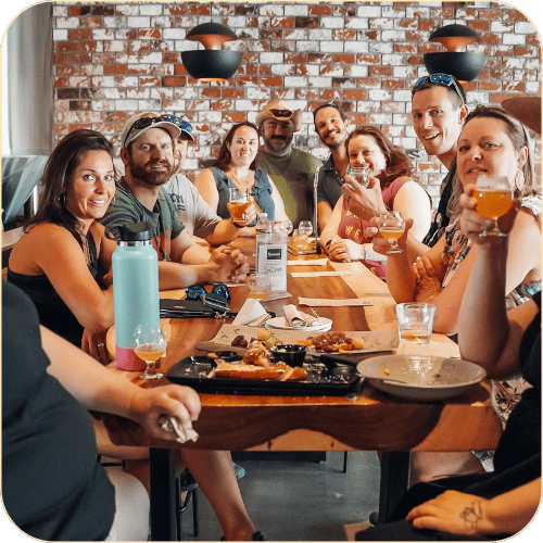 group of friends gathered around a table on a San Diego beer tour