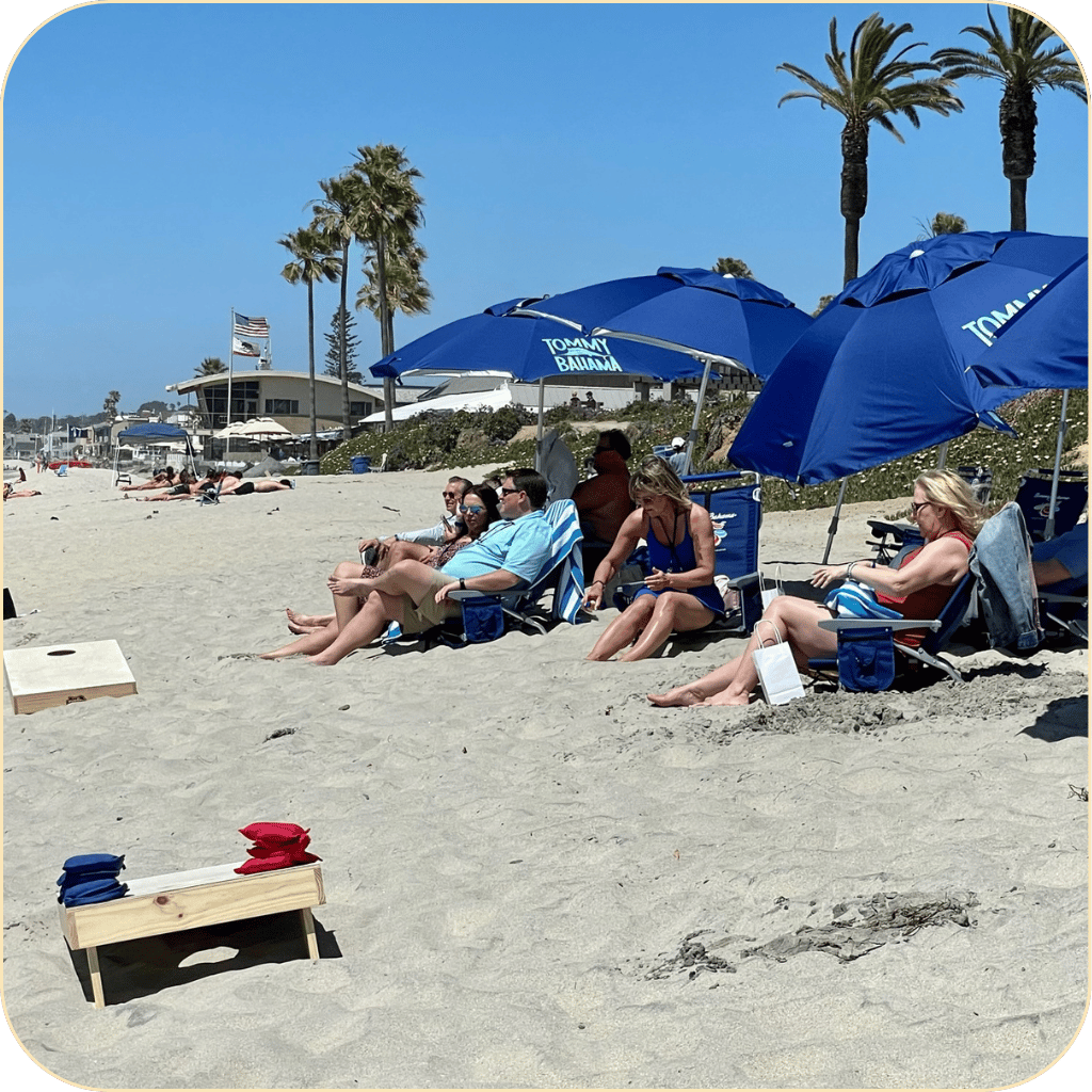 san diego walking tour group sitting on the sand under umbrellas