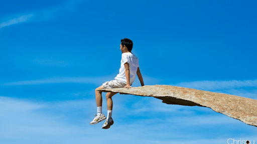 Man hanging on the clif of "Potato Chip Rock"