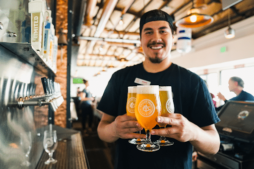 man holding craft beer glasses