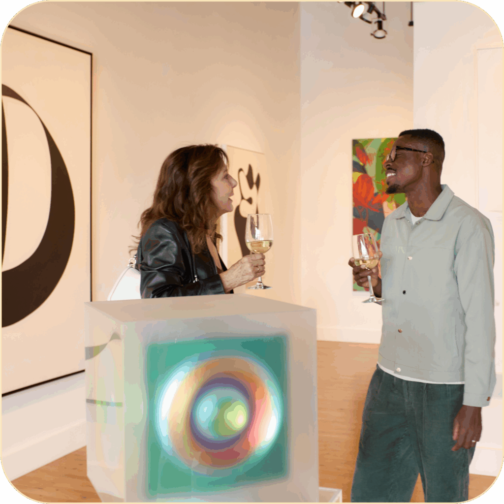 two people holding drinks and chatting in art gallery